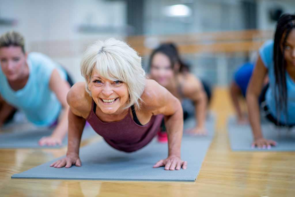 Woman with hearing loss at a yoga class.