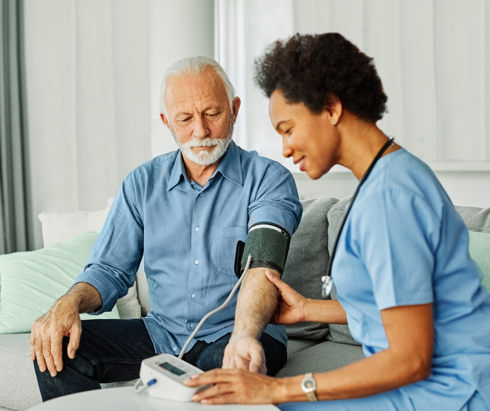 Nurse taking man's blood pressure.